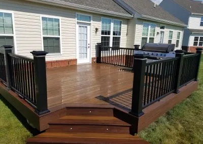 composite deck with black railing and integrated step lighting