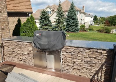 stone outdoor island with built-in grill for entertaining