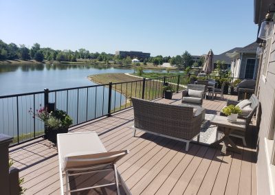 large composite deck build with seating areas and water view