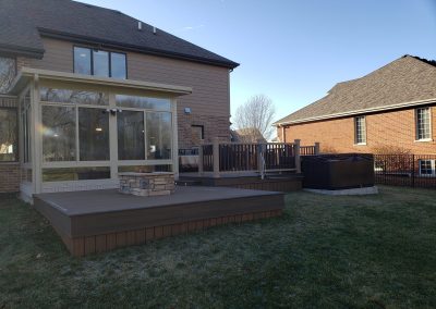 multi-level composite deck with built-in fire pit and integrated lighting