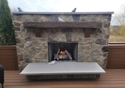 outdoor stone fireplace on composite deck