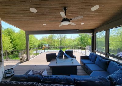outdoor living design and build - composite deck with deck cover, integrated lighting, outdoor fan, and large seating area
