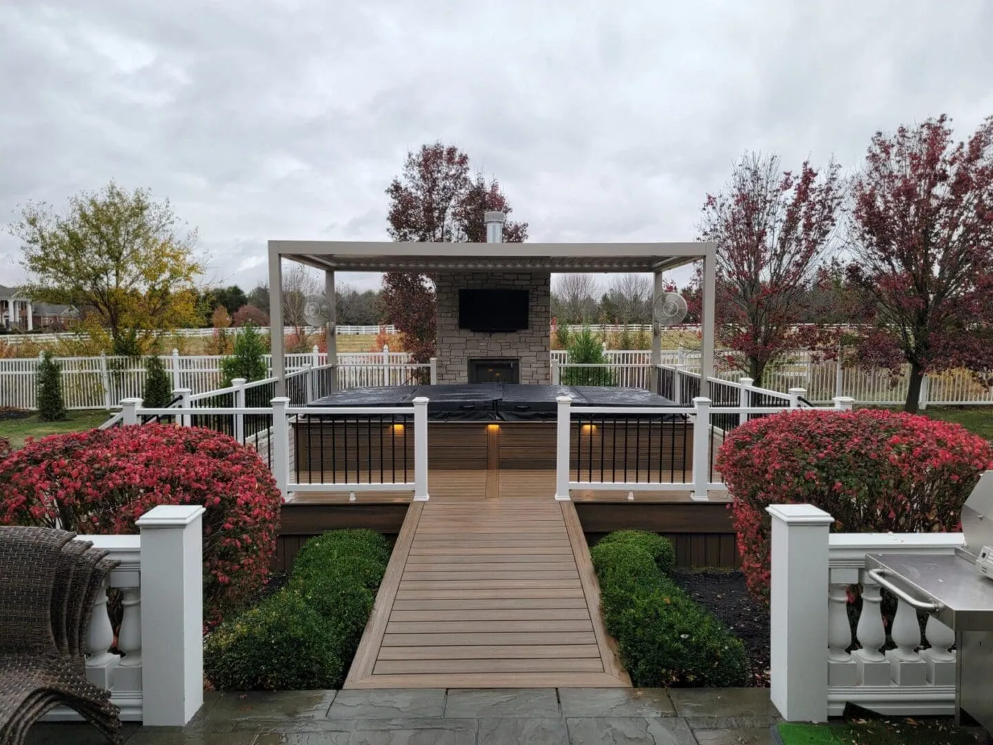 covered composite deck with outdoor fireplace