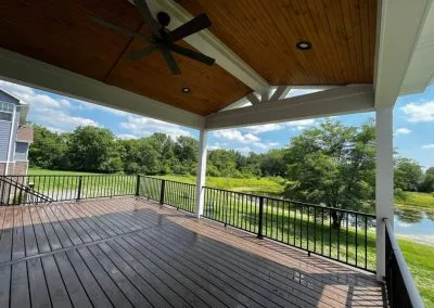 covered composite deck with wood ceiling and ceiling fan