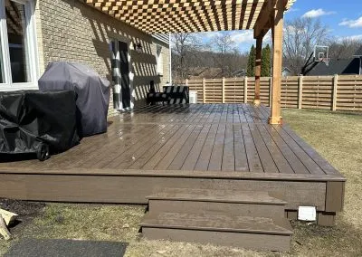 composite deck build with pergola in backyard