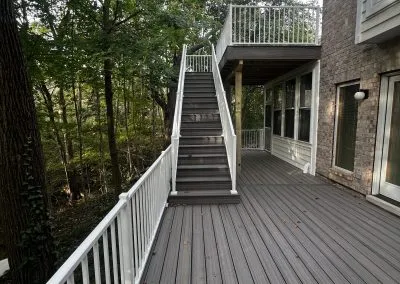 multi-level composite deck build with stairway and white railing