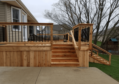 cedar deck with multiple stairways and black spindles