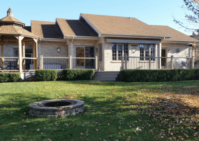 large backyard deck spanning the entire house with pavilion