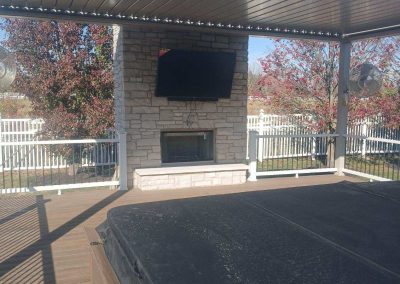 covered deck with outdoor fireplace
