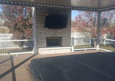 covered deck with outdoor fireplace