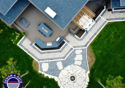 Outdoor living space with composite deck, integrated seating, pergola, outdoor kitchen and built-in fire pits