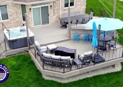 outdoor living design with outdoor kitchen, hot tub, built-in fire feature and seating for entertaining
